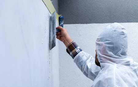 Professional painter applying wall finish with precision